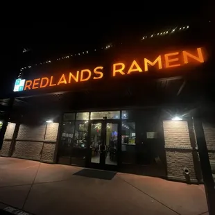 the front of the restaurant at night