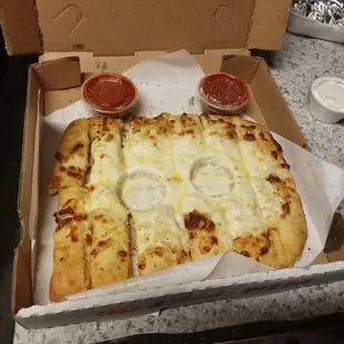 I hope whoever did this didn&apos;t think it was a brilliant idea to put the sauce cups on top on the bread sticks. Ugh