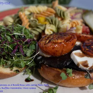 Grilled Portabello mushroom,Garlic-Pesto Aioli, Oven Roasted Tomato, Buffalo Mozzarella, Micro Greens
 with a Balsamic Drizzle