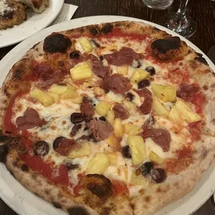 Pizza with pineapple, olives, ham
