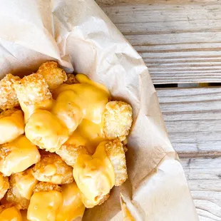 a basket of cheesy tater tots