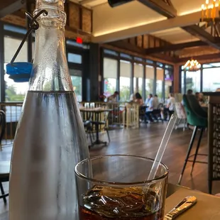  glass of soda and a bottle of soda