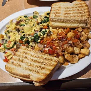 The "Dolly Parton" scramble with country potatoes and extra peppers and onions ($1 extra) and AWESOME sourdough toast.