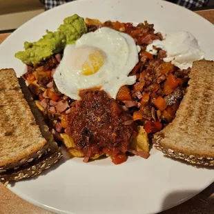 The "John Wayne" with an egg (extra) and wheat toast. Avocado and sour cream on the side.