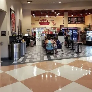 people sitting at tables in a restaurant