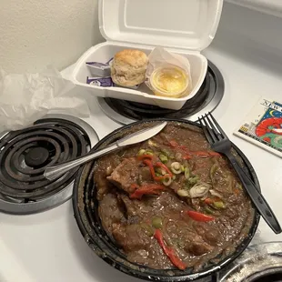 8/17/23 Smothered pork chops and grits, with buttermilk biscuits.