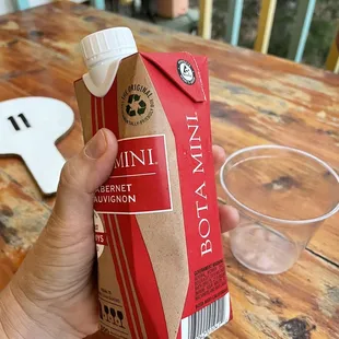 a hand holding a carton of red's pizzeria