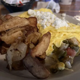 an omelet, potatoes, and hash browns