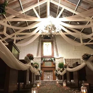 the inside of a church decorated for a wedding