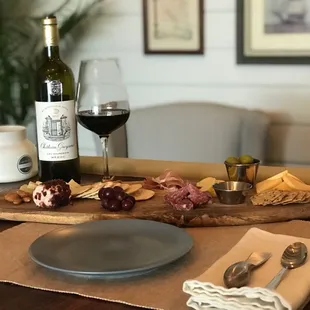 Along with other bites like chocolates and olives- our charcuterie board pairs lovely with our wines!
