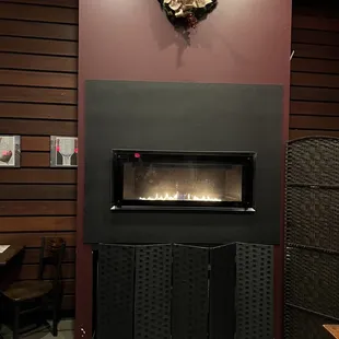 a fireplace with a wreath on the wall