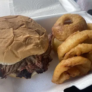 ows a pulled pork sandwich and onion rings