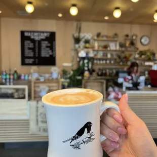 a hand holding a cup of coffee