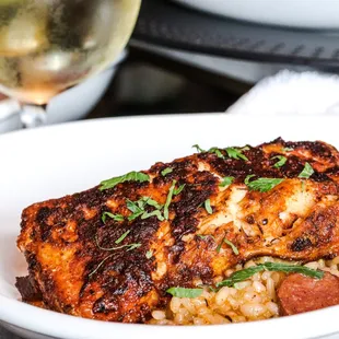 a plate of food and a glass of wine