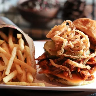 a pulled pork sandwich and french fries