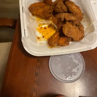 fried chicken and eggs in a styrofoam container