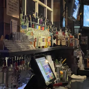 a bar with a lot of liquor bottles