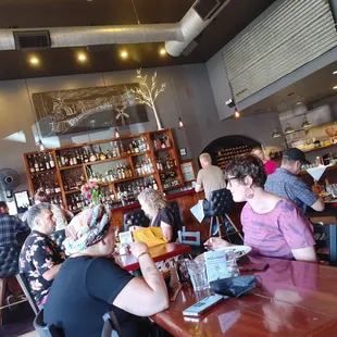 a group of people sitting at a table in a restaurant