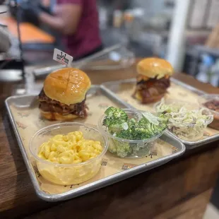 Brisket sandwiches with mac n cheese and delicious broccoli - and on the other plate baked beans and slaw