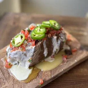 a baked potato topped with jalapenos