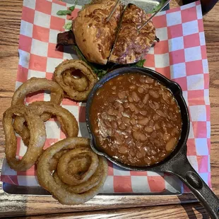 Redwood burger with cheese and bacon with baked beans and onion rings.