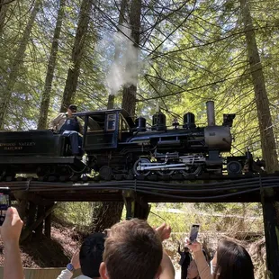The steam engine at the front of the train -- crossing over a bridge