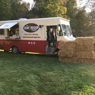 the food truck parked in the grass