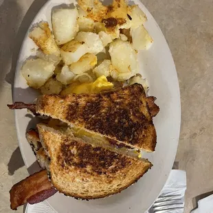Bacon, egg and cheese on wheat with hash browns