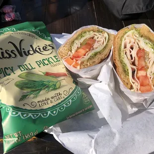 Turkey with pesto with pickles on wheat bread and with this awesome chips