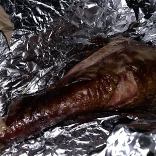 a piece of meat wrapped in tin foil
