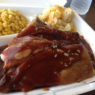 a plate of meat and corn