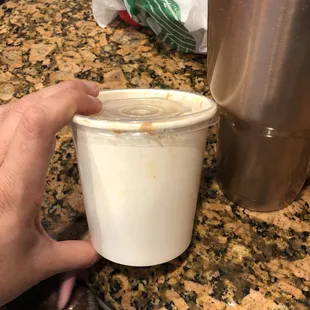 a hand holding a cup of coffee