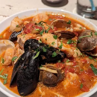 Cioppino- classic seafood stew with fish, shrimp, scallops, clams, mussels, and crab in a warm broth