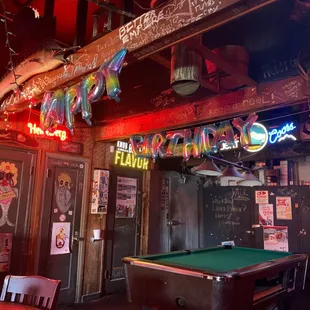 a pool table and neon signs