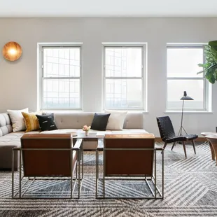 a living room with a couch, chairs, and a coffee table