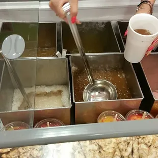 Aquas frescas (fruit punch) are stored in refrigerated cooler.