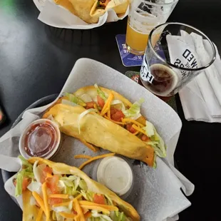 Up close the 2 fried tacos, distance big ole taco salad, a fairy nectar and samual jackson october fest beers