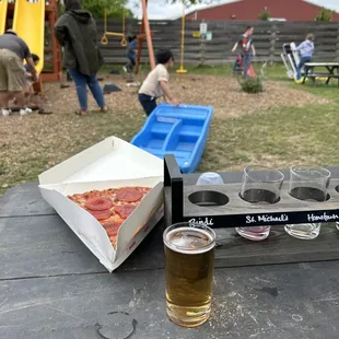 Beer flight $14 and pizza slice $5. Cool spot very family friendly