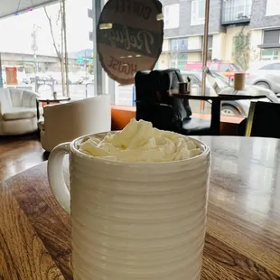 a cup of coffee with whipped cream