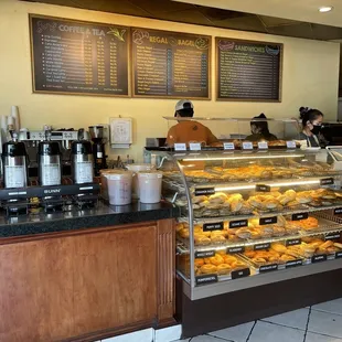 a bakery counter with a variety of pastries