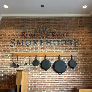 a brick wall with pans hanging on it