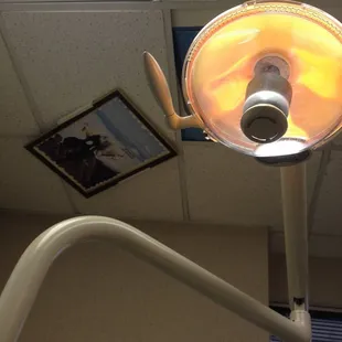 Ceiling poster says "So, whose idea was this anyway?" Classic rock in the background.