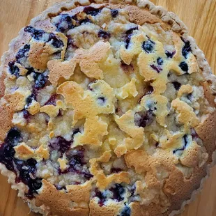 a blueberry pie on a wooden table