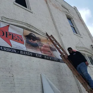 a man standing on a ladder