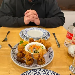 a man sitting at a table with plates of food
