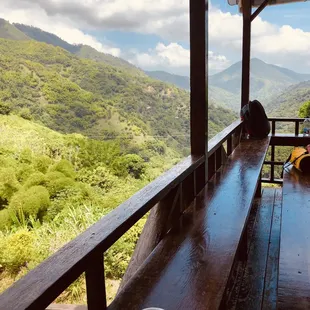 a woman sitting on a bench with a cup of coffee