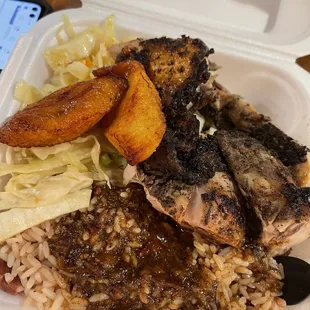 Jerk chicken with oxtail gravy over rice