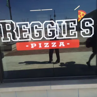 the reflection of a person in the window