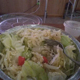 a salad with a fork in it