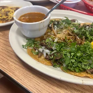 a plate of tacos and a bowl of soup